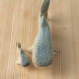 Bumbu handmade and hand painted wooden grey whale shark figure next to a baby whale shark figure available at Babipur 