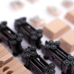 A closer look at the wheel bases of the Candylab DIY Candycar Castor Set - 12 Pack, with wooden blocks and car parts surrounding