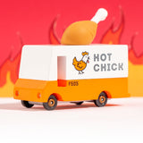 The The Candylab Candyvan - Fried Chicken Van from a side angle on a red fiery background