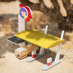 The Candylab Rocket Fuel Station under the shade of a cactus with a desert background