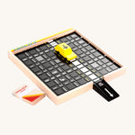 The Candylab Gridlock Puzzle Board Game, with a yellow wooden car on the traffic puzzle board, game cards and a black ramp attached to the board, on a cream background