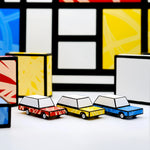 The Candycars which have been constructed from the Candylab DIY Candycar Castor Set - 12 Pack, in red, yellow and blue. With Red, Yellow and Blue art work surrounding the cars to give an art-pop feel