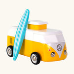 The Candylab VW Beach bus in yellow, with a wooden blue and white stripe surf board propped up next to the van, The image is on a cream background