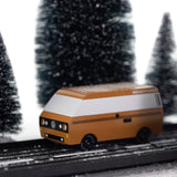 CandyLab VW T3 Campervan in brown - side view, placed on a road in a snowy forest environment.