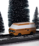 CandyLab VW T3 Campervan in brown - side view, placed on a road in a snowy forest environment.