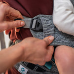 A closer view of the adjustable, adaptive sizing straps on the side of the Carifit+ Multi-Position Baby Carrier in Cool Grey