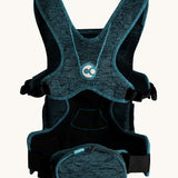 Carifit+ Fabric Baby Carrier in Cool Green, shown from the back showing the adjustable straps and zip up storage pouch, on a cream background