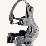 The Carifit+ Baby Carrier in Cool Grey from the side showing the adjustable adaptive straps on the side and waist, on a cream background