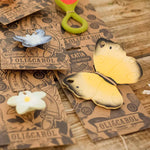 The Oli & Carol Natural Rubber Teether - Katia The Butterfly with other Oli & Carol teethers on their cardboard packaging slip