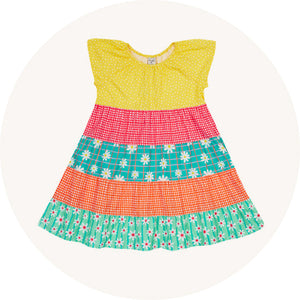 Frugi Dorothy Twirly Dress Rainbow Hotchpotch - ruffled sleeves, elasticated neckline and made from organic cotton poplin. Patchwork design with a blue daisy print, yellow polka dots, red and orange gingham.