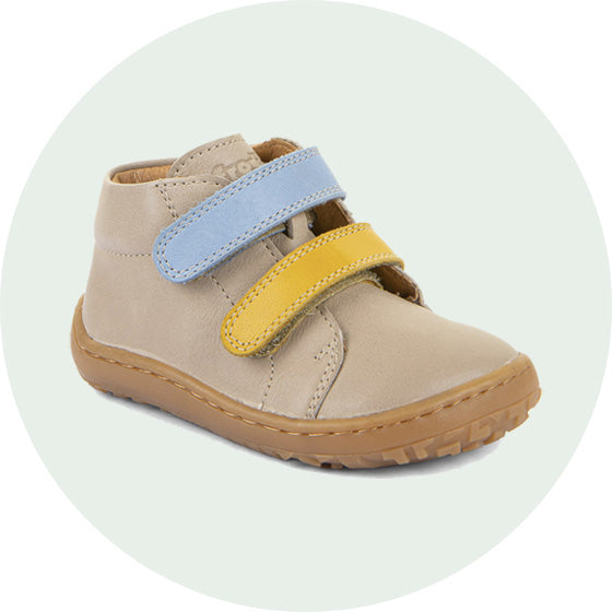 Froddo barefoot first step kids shoes in beige with yellow and blue Velcro straps, to represent barefoot baby and toddler shoes at Babipur.