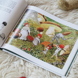 Children of the forest children's book by Elsa Beskow. Illustration features toadstool children collecting berries and conkers in autumn.