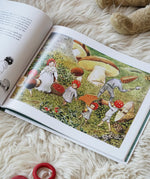 Children of the forest children's book by Elsa Beskow. Illustration features toadstool children collecting berries and conkers in autumn.