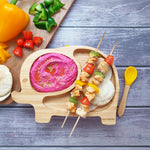 Elephant bamboo baby weaning plate with chicken and vegetable kababs, a pink dip and mini flatbreads,  with a yellow silicone and bamboo baby spoon.