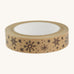 Christmas paper tape with brown snowflake design on cream background.