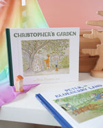 Christopher's Garden children's hardback book by Elsa Beskow on shelf next to another book from the series, Peter in Blueberry Land.