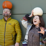 Cocoa Loco Halloween eyeball chocolate worn by Jolene and Pete from team Babipur. They're outside pulling spooky faces with pumpkins on their heads.