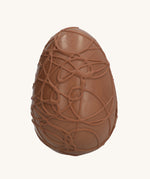 Cocoa Loco Fairtrade organic milk chocolate Easter egg, hand crafted with intricate chocolate swirls.