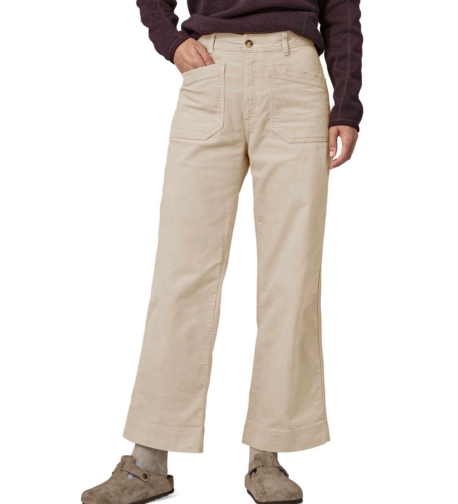 A person wearing thePatagonia Women's Wide Leg Cord Pants - Pumice, showing the flared style cut of the trouser legs