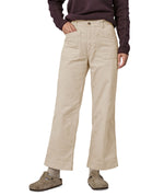 A person wearing thePatagonia Women's Wide Leg Cord Pants - Pumice, showing the flared style cut of the trouser legs