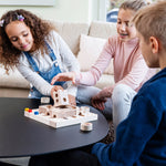 Three children playing with the Cuboro Tricky Ways Board Game on a black table