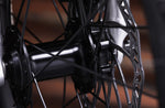 Close-up of a bicycle hub and disc brake system