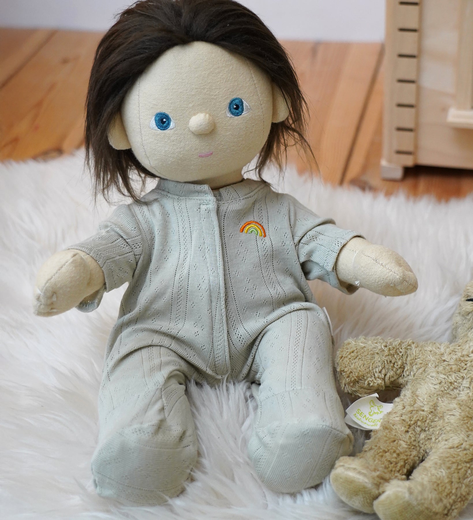 Olli Ella Dinkum Doll wearing a light green sage pointelle PJ set with vest, pants, and babygrow, sold at Babipur.