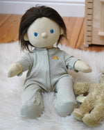 Olli Ella Dinkum Doll wearing a light green sage pointelle PJ set with vest, pants, and babygrow, sold at Babipur.