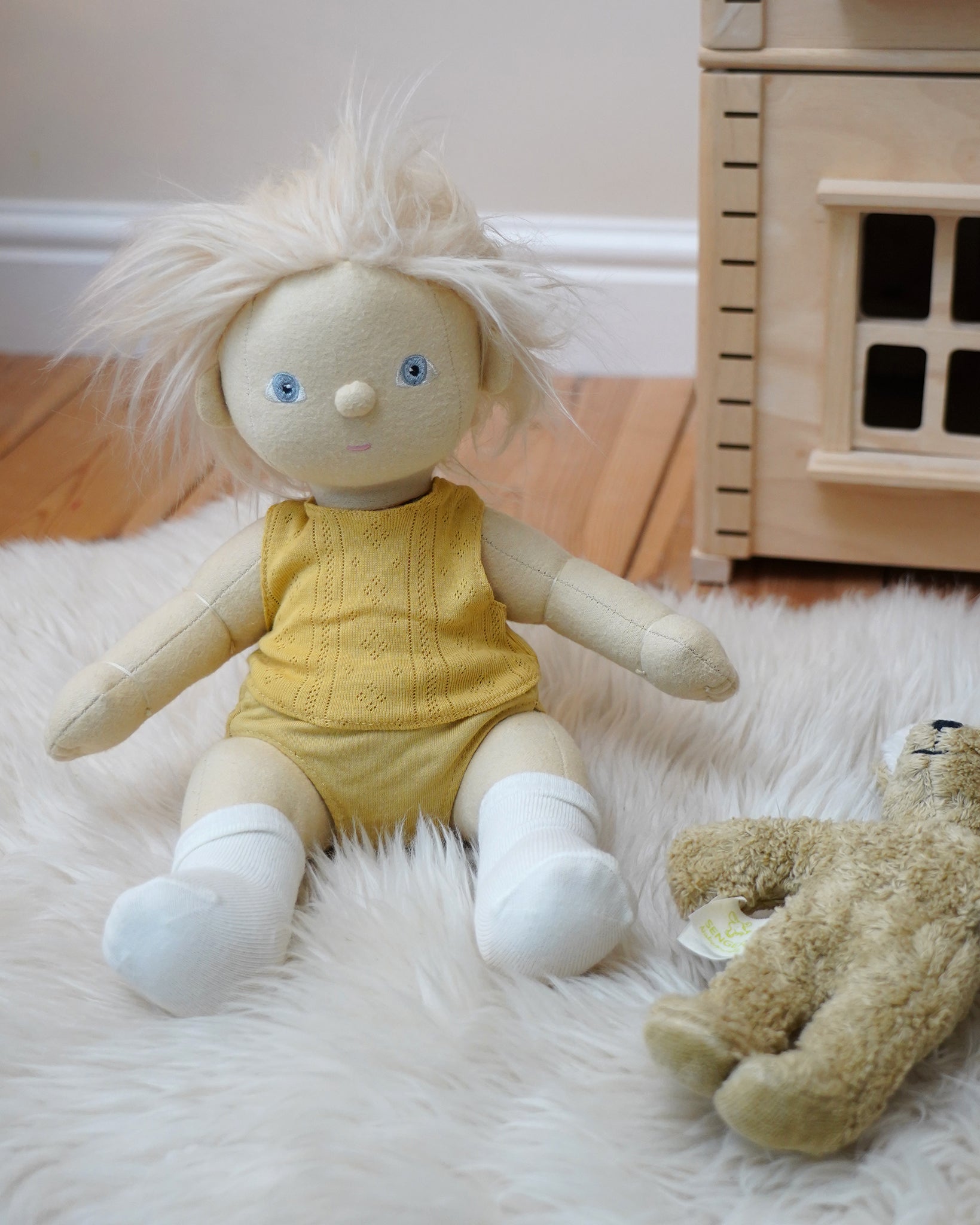 Dinkum Doll from Olli Ella dressed in a vest and pants from the honey yellow pointelle PJ set, it also comes with a matching babygrow - buy now at Babipur. 
