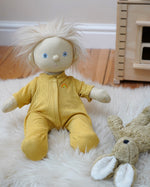 Olli Ella Dinkum Doll wearing a honey yellow pointelle PJ set - comes with a vest, pants and matching romper - sold at Babipur.
