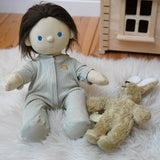 Olli Ella Dinkum Doll wearing a sage pointelle PJ set -  comes with a vest, pants and babygrow in a light green pattern - for sale at Babipur. 