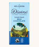 Divine fairtrade 90g smooth milk chocolate bar in blue wrapping with cocoa farm illustration on the front