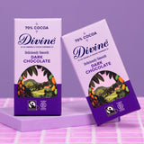 2 bars of Divine fairtrade smooth 70% dark chocolate standing on a purple platform