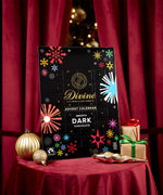 Divine fairtrade milk chocolate advent calendar available at Babipur. Showing the front of the calendar. Calendar is displayed with festive decorations.