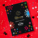 Divine fairtrade milk chocolate advent calendar available at Babipur. Showing the festive inspired design on the front with a red festive background.