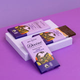 3 bars of Divine fairtrade smooth dark chocolate displayed on a platform
