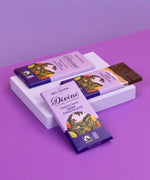 3 bars of Divine fairtrade smooth dark chocolate displayed on a platform