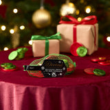 Divine fairtrade milk chocolate inside the green netted bag with various festive decorations in a background. Chocolate coins available at Babipur 