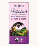 Front of Divine fairtrade smooth dark chocolate bar with fruit and nut in light purple wrapping with a cocoa farm illustration 