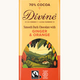 Front of Divine fairtrade smooth dark chocolate bar with ginger and orange in yellow wrapping with a cocoa farm illustration 
