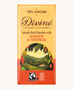 Front of Divine fairtrade smooth dark chocolate bar with ginger and orange in yellow wrapping with a cocoa farm illustration 