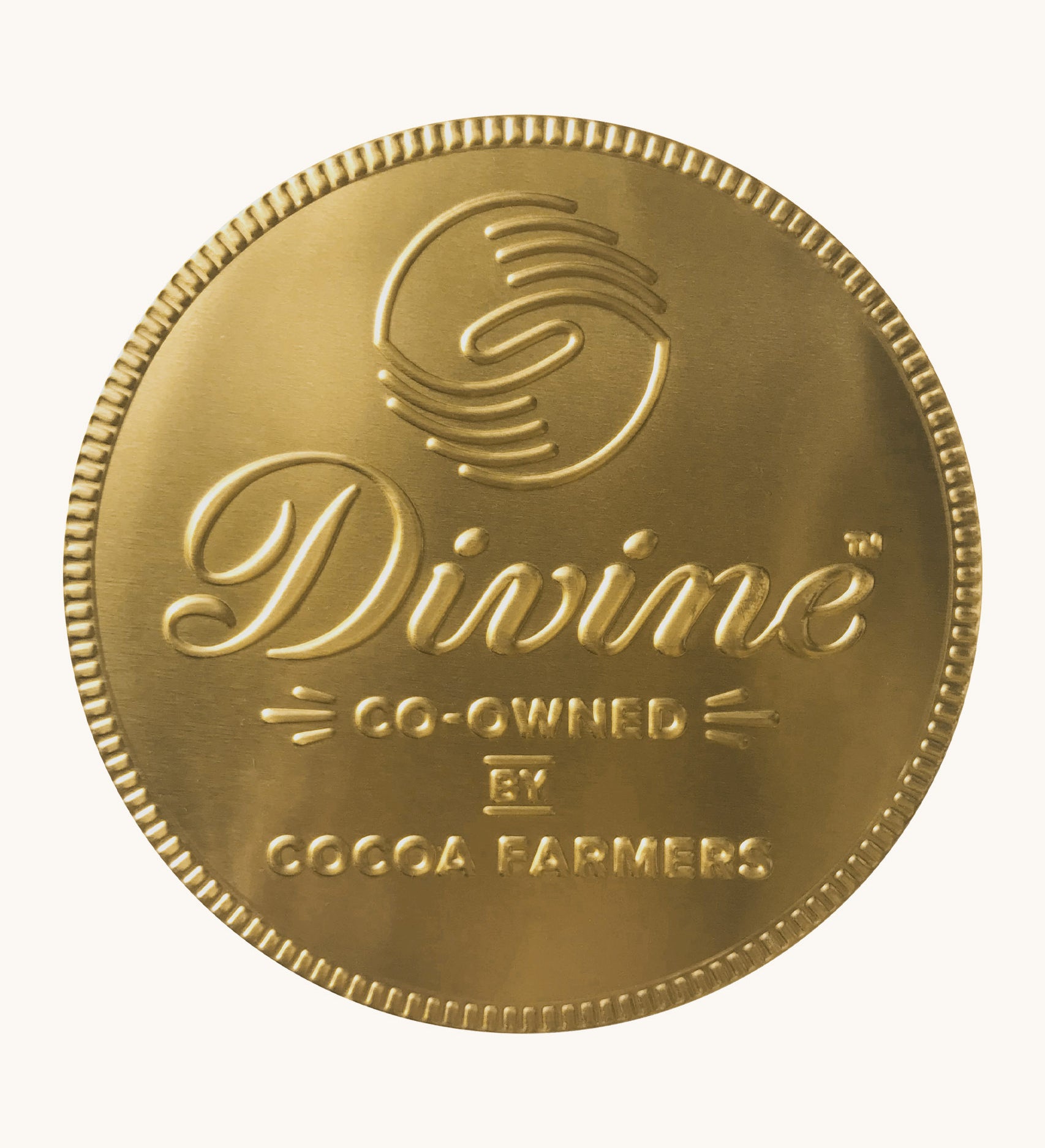 Divine fairtrade giant milk chocolate coin available at Babipur wrapped in gold foil with branding on the front. 
