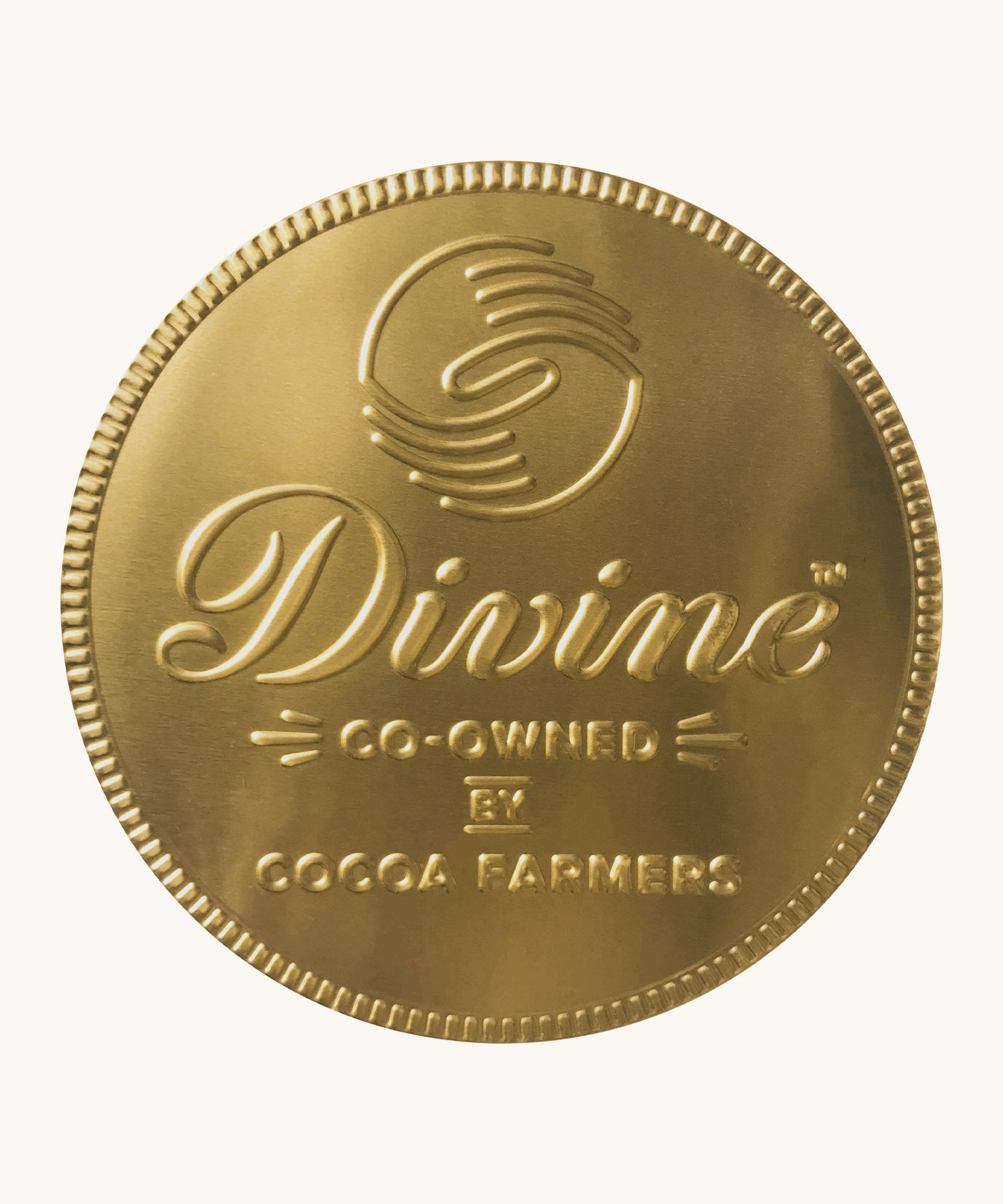 Divine fairtrade giant milk chocolate coin available at Babipur wrapped in gold foil with branding on the front. 