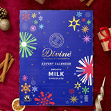 A flatlay with the Divine fairtrade milk chocolate advent calendar laid next to festive decorations. Calendar available at Babipur  