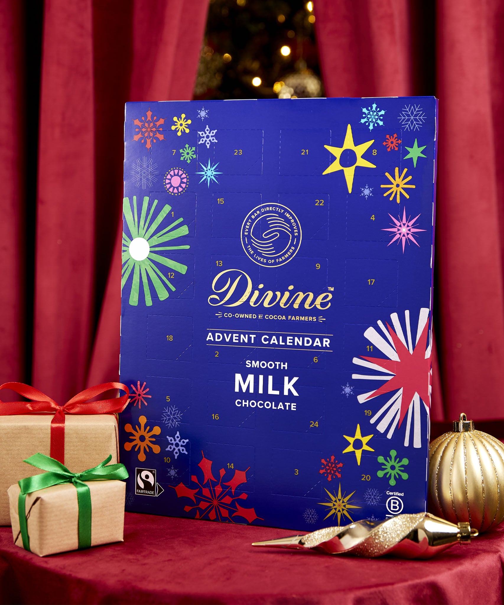 Divine fairtrade milk chocolate advent calendar available at Babipur. Showing the front of the calendar. Calendar is standing in a festive display.
