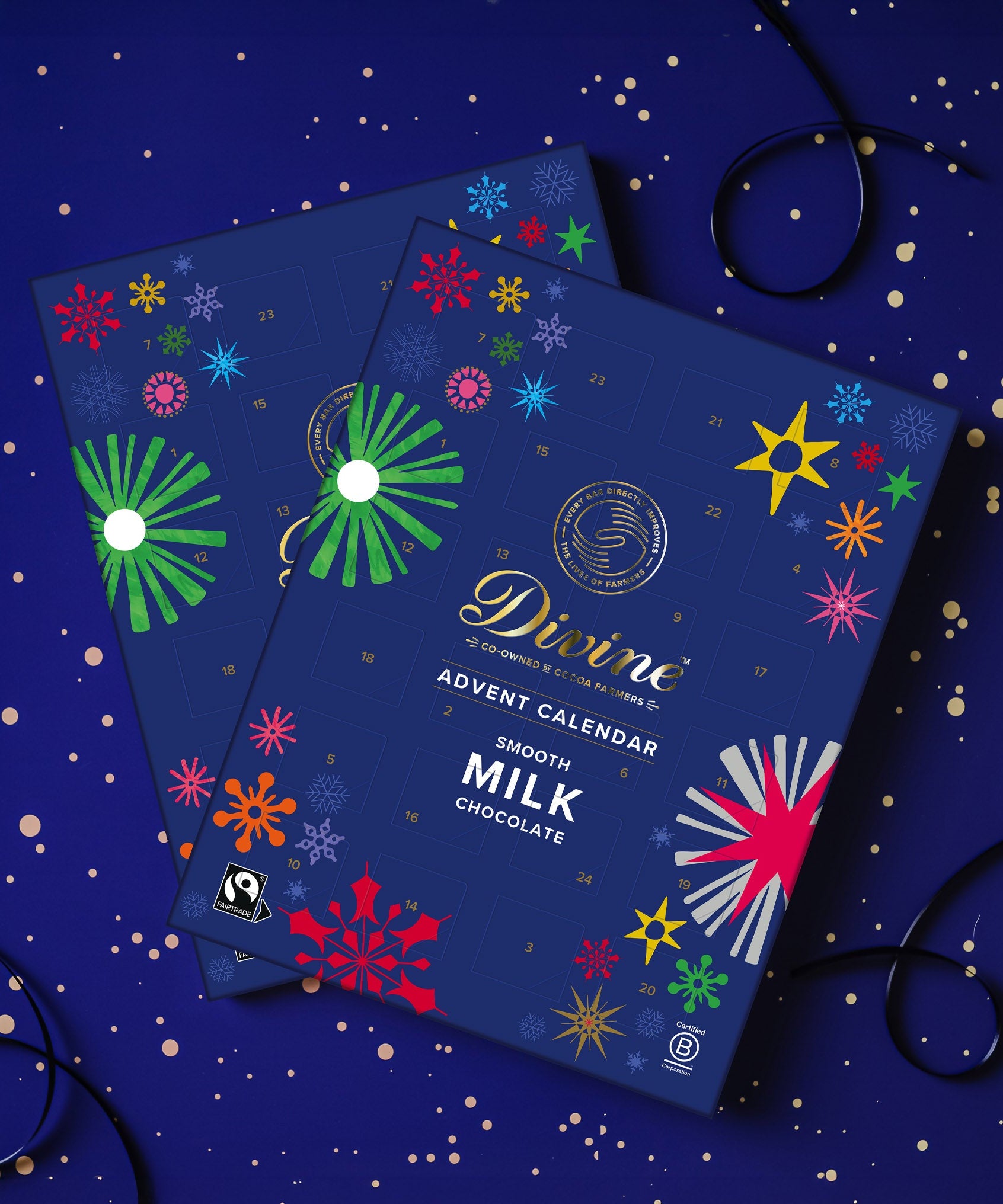 A pair of Divine fairtrade milk chocolate advent calendar available at Babipur. Showing the festive inspired design on the front with a matching festive background.