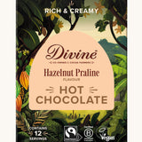 Front of Divine fairtrade luxury hot chocolate with hazelnut praline box shows a illustration of a cocoa farm