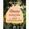Front of Divine fairtrade luxury hot chocolate with hazelnut praline box shows a illustration of a cocoa farm