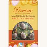 Divine Fairtrade milk chocolate mini eggs with smooth caramel displayed in a decorated yellow and orange box