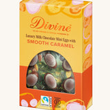 Side of Divine Fairtrade milk chocolate mini eggs with smooth caramel displayed in a decorated yellow and orange box 